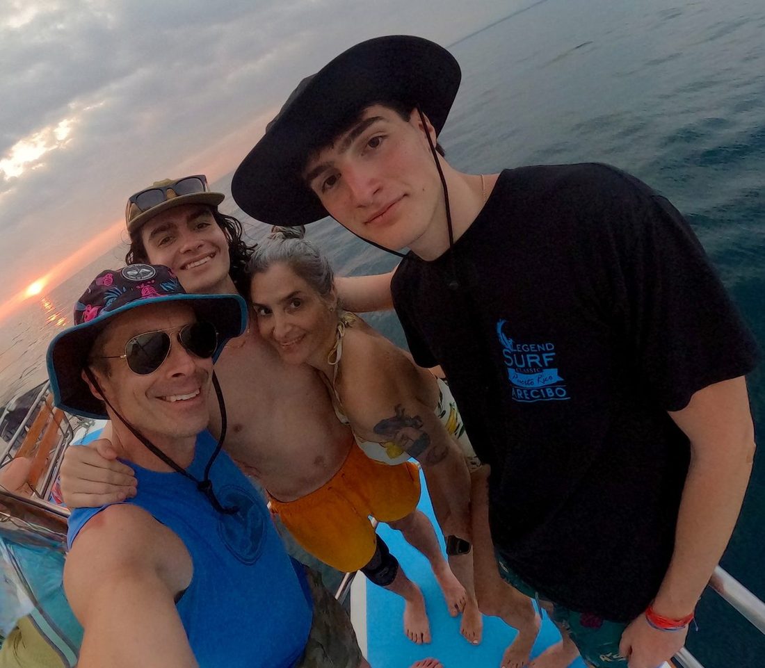 Will Yandell with his family on a boat at sunset
